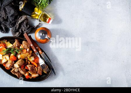 fried potato with liver on metal plate Stock Photo