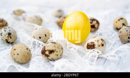 Traditional yellow Easter egg on white vintage tablecloth. Easter idea Stock Photo