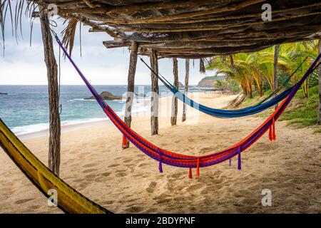 Hammocks on the Palma Sola beach on the Pacific coast of Mexico. Stock Photo