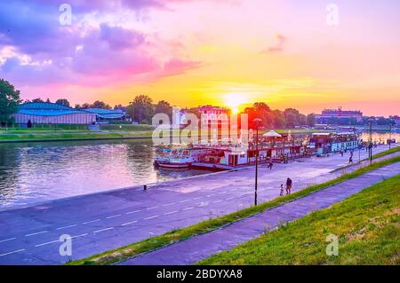 KRAKOW, POLAND - JUNE 12, 2018: The twilights above Vistula river in Krakow, with barges-restaurants moored to banks, on June 12 in Krakow Stock Photo