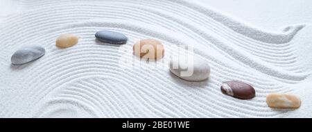 Zen pebbles on white sand pattern Stock Photo