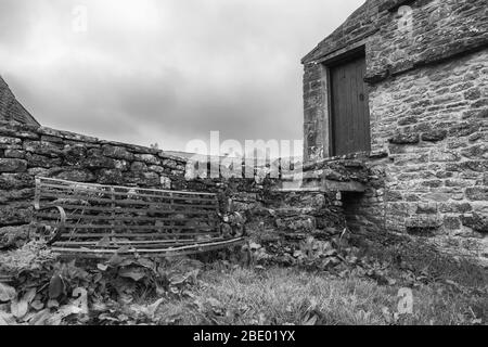Bench and barn in Keld, Swaledale, North Yorkshire, England, UK.  Black and white version Stock Photo