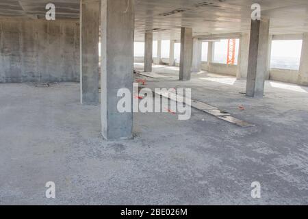 Concrete colums on the floor of a building under construction. Concrete structure construction site. Stock Photo