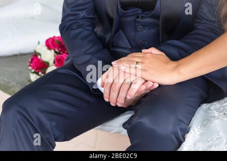 Newly wed couple's hands with wedding rings, detail. Stock Photo