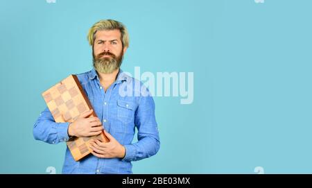 bearded man hold chess board. intelligence quotient. human brain working. brainstorming concept. play chess tournament. copy space. Intelligence level measurement. level up your iq. copy space. Stock Photo