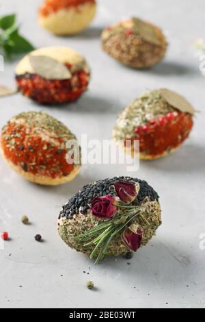 Eco-design of Easter eggs with various spices and cereals, without dyes and preservatives on a gray concrete background, Vertical format Stock Photo