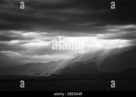 Epic, dramatic sunrays seeping through the clouds over the Andes ...