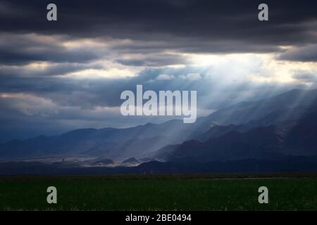 Epic, dramatic sunrays seeping through the clouds over the Andes ...