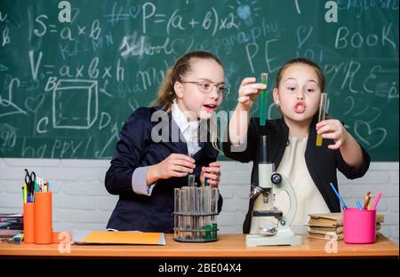 Hard choice. Chemistry research. Biology science. Happy little girls. Little girls in school lab. Science is future. science experiments in laboratory. Little girls scientist work with microscope. Stock Photo