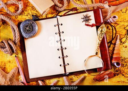 old notebook, loupe and compass on the map Stock Photo