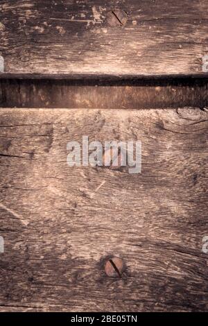 Rustic, weathered wooden plank with a rusty screw on it. Testure detail, close up. Stock Photo