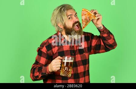 bachelor men club. Having fun and drink in bar. nice pub menu. man watching football while drinking beer and eating pizza. eating pizza and drinking. take-away pizza. Best party here. Stock Photo