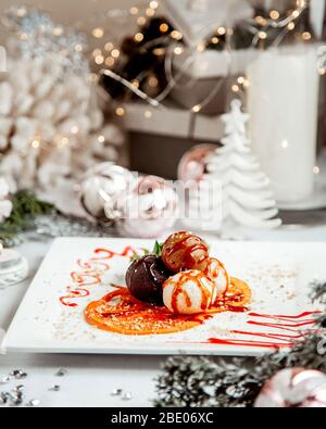 dessert balls topped with fruit syrup Stock Photo