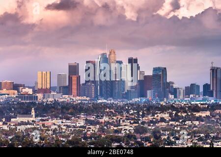 Sunset view of Los Angeles skyline and surrounding area with storm clouds covering the sky; Stock Photo