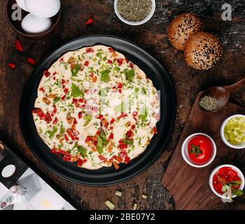 fried eggs with sliced vegetables and herbs Stock Photo