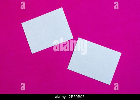 white paper cards or sticky notes on pink wall Stock Photo