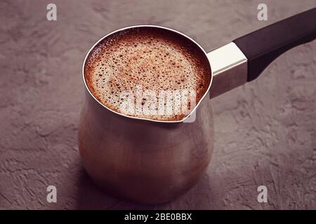 Freshly made coffe in Turkish coffee brewing pot Stock Photo