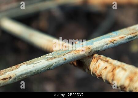 Old blue paint weathered rusty rough metal rods material details macro close-up background Stock Photo