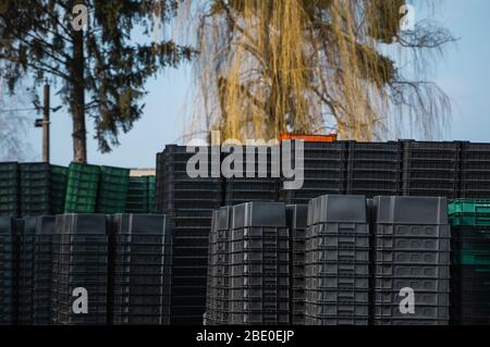 Black plastic boxes in a warehouse outdoor. Stock Photo
