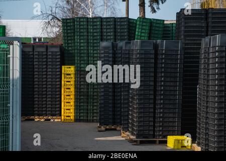 Black plastic boxes in a warehouse outdoor. Stock Photo