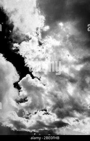 Black & white of unusual cloud formations against clear cobalt blue sky; central Colorado; USA Stock Photo