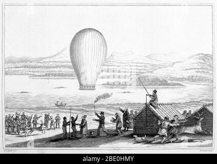 The natives of Tornea Lapmark, assembled at Enontekis in Lapland to witness the launch of the first Balloon within the Arctic Circle. From 'Travels in various countries of Europe Asia and Africa' by Edward Daniel Clarke. Published: 1819. A man sitting on the roof of a store house is holding a pole from which the balloon had been suspended; another man holds a stick burning at one end from generating the heat to inflate the balloon. Many Laplanders in foreground watch the balloon ascension while reindeer, frightened by the balloon, scamper off. Stock Photo