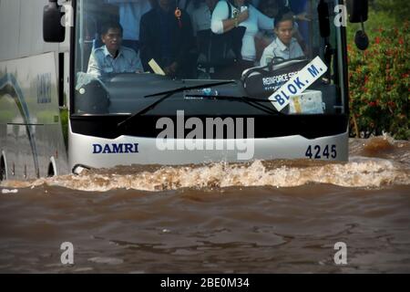 Jakarta Airport shuttle bus passing through flooded toll road in 2008. Archival Image. Photo: Reynold Sumayku Stock Photo