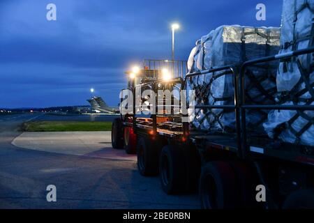 Airmen from the 146th Airlift Wing of the California Air National Guard in Oxnard, CA, deliver 200 ventilators to the  New York Air National Guard's  105th Airlift wing on April 7, 2020, at Stewart Air National Guard Base, Newburgh, NY. The use of the C-130J Super Hercules, along with the help of New York Army National Guard Sodliers from the 369th Sustainment Brigade, facilitated the shipment of medical equipment, which will support the ongoing COVID-19 medical response being conducted in the New York and New Jersey areas. Each state will receive 100 of the ventilators  (U.S. Air National Gua Stock Photo