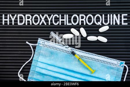 Hydroxychloroquine Vaccine and pills on letter board, a possible treatment for Corona virus Covid 19 Stock Photo