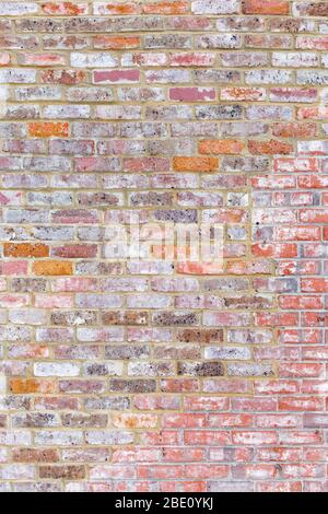 Old brick wall with multi-coloured bricks. Background image, portrait Stock Photo