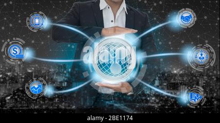 Ripple and cryptocurrency investing concept - Businessman holding Ripple (XRP) with mobile application business icons showing exchanging, trading, tra Stock Photo