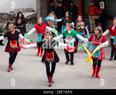 Beijing, China - March 8, 2015: Group of women performing a traditional dance in Beihai park on International Women's Day Stock Photo