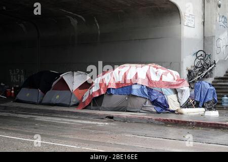 Los Angeles, United States. 10th Apr, 2020. Los Angeles, USA. April 10 2020: A homeless encampment underneath the Alvardo Street under pass below the Interstate 101 freeway amid the global coronavirus COVID-19 pandemic, Friday, April 10, 2020, in Alhambra, Calif. (Photo by IOS/Espa-Images) Credit: European Sports Photo Agency/Alamy Live News Stock Photo