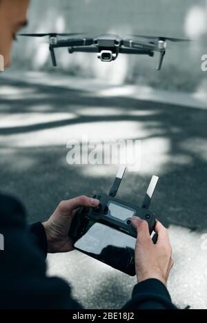 Drone remote control. Remote control in hand man. Man holds remote controller with his hands and controls the drone Stock Photo