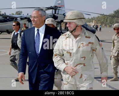 US Army Colonel William Mayville, Commander, 173rd Airborne Brigade (ABN BDE) welcomes US Secretary of State Colin L. Powell upon his arrival at Kirkuk Air Base (AB), Iraq. The Secretary is visiting numerous locations throughout Iraq including Baghdad, and Kirkuk to meet with the troops supporting Operation IRAQI FREEDOM. Stock Photo