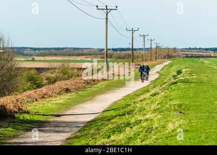 Cyclists on Cheshire Lines path, West Lancashire, part of the Trans-Pennine Trail Stock Photo