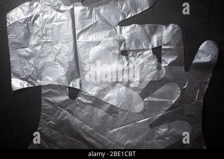 Plastic gloves on a black table. Stock Photo