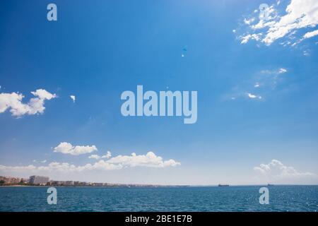 Seascape with sea horizon and almost clear bright blue sky Stock Photo