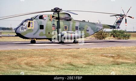 Left side view of a HH-3E Jolly Green Giant helicopter parked on the runway apron. Stock Photo