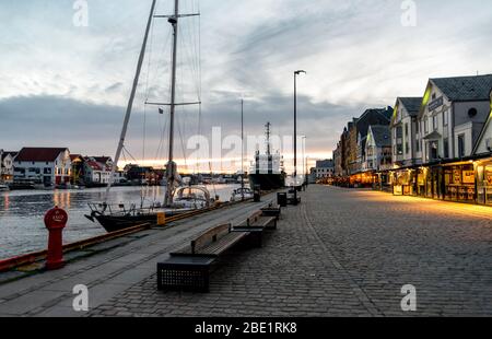 Walking promenade in the evening at Haugesund city center and harbor with restaurants, cafes and recreational boats parked, Haugesund, Norway, May 201 Stock Photo