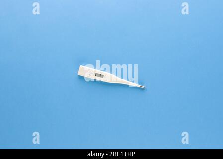 Clinical digital thermometer for checking body temperature isolated on light blue background Stock Photo
