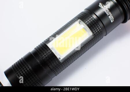 modern black metal flashlight isolated on white background Stock Photo