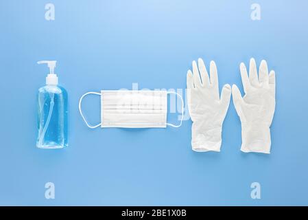 Medical mask, gloves and alcohal gel hand sanitizer for protecting from infection during COVID-19 pandemic Stock Photo