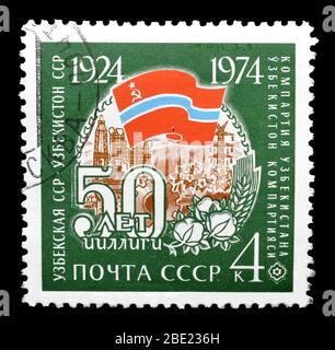 Cancelled postage stamp printed by USSR, that shows Coat of arms of Uzbekistan, circa 1974. Stock Photo