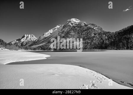 Panoramic view of Lake Predil, the five peaks and the Alps around Tarvisio in black and white, Italy Stock Photo