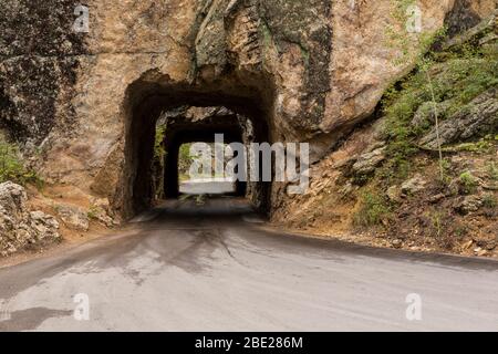 Two Narrow Tunnels On A Road In The Black Hills Of South Dakota. Stock Photo