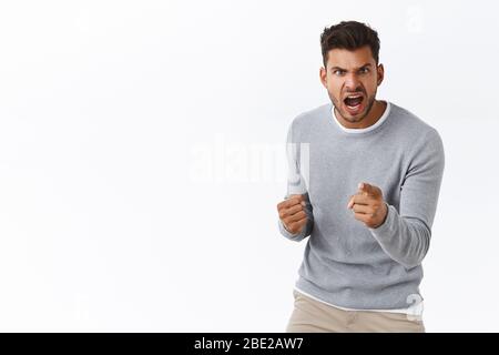 Man threatening person with angry outraged expression, lose temper standing distressed, pointing camera accuse someone, blame girlfriend, having Stock Photo