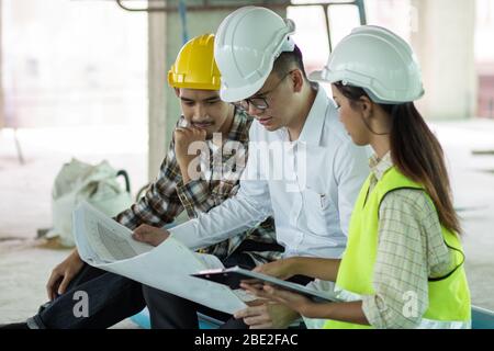 Team of engineer planning and checking project on blue print Stock Photo