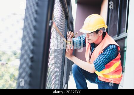 inspector checking and measuring tape measure in building Stock Photo