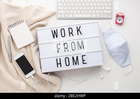 Work from home word on lightbox with working stuff and mask, quarantine for coronavirus or covid-19 Stock Photo